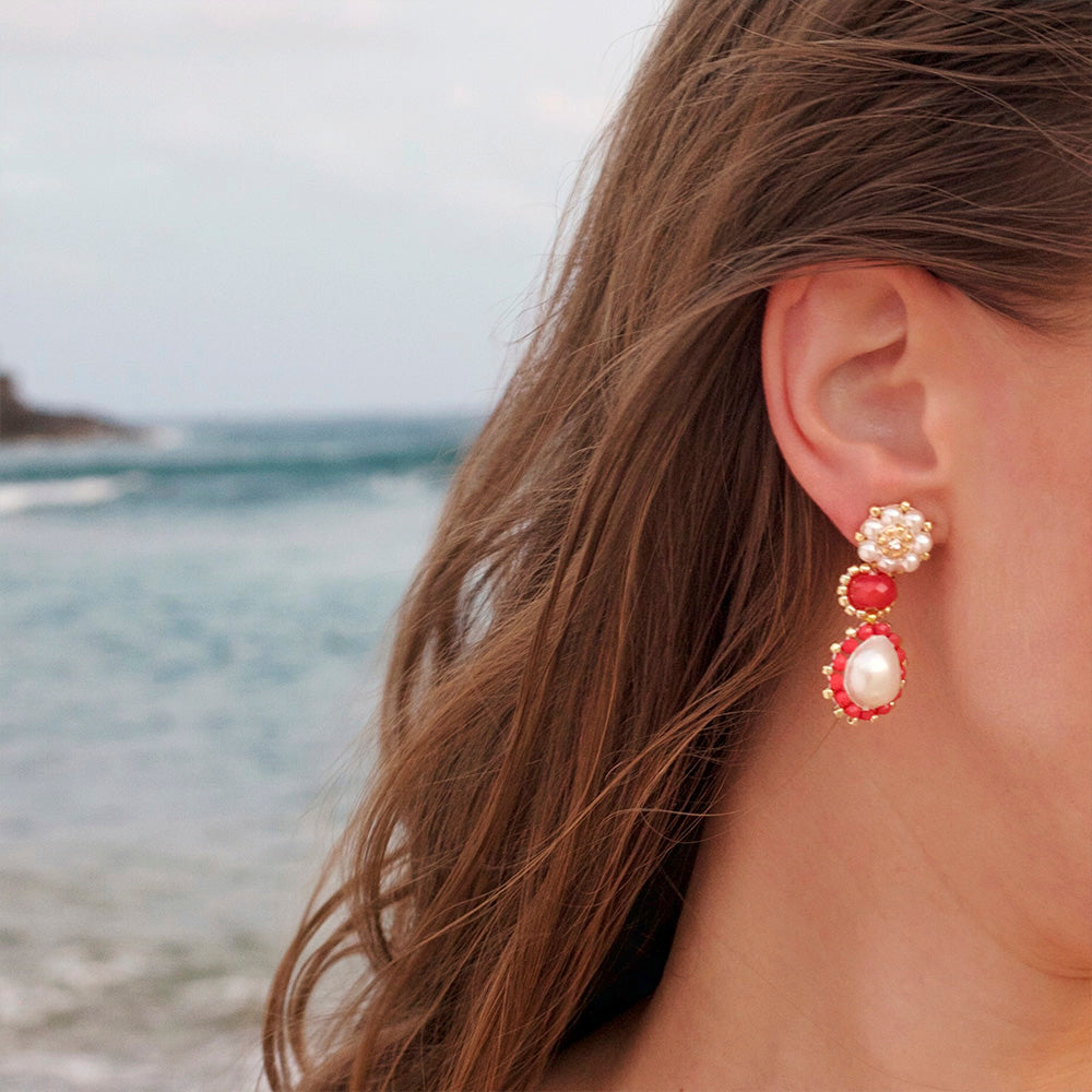 woman wearing natural summer earrings made from orange gemstone and natural pearls