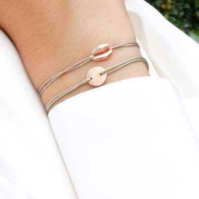 glittery beige nylon thread bracelet with rosegold cowrie shell
