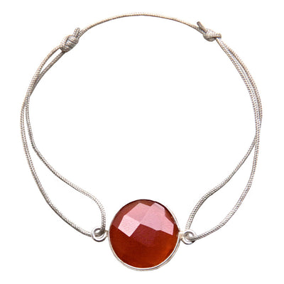 beige nylon thread bracelet with round red quartz gemstone
