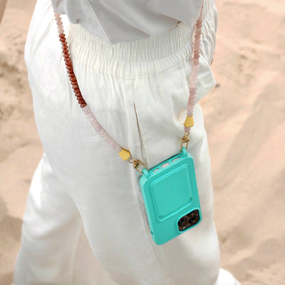 Wear a white summer beach outfit with your matching ocean-blue phone case and trendy nude and gold summer chain necklace.