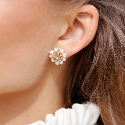 A woman with pearl stud earrings.