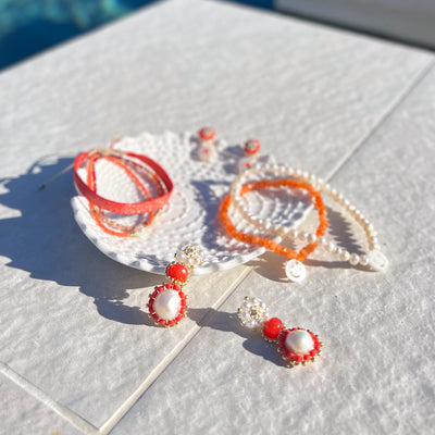 orange and white summer jewelry made from natural gemstones and freshwater pearls