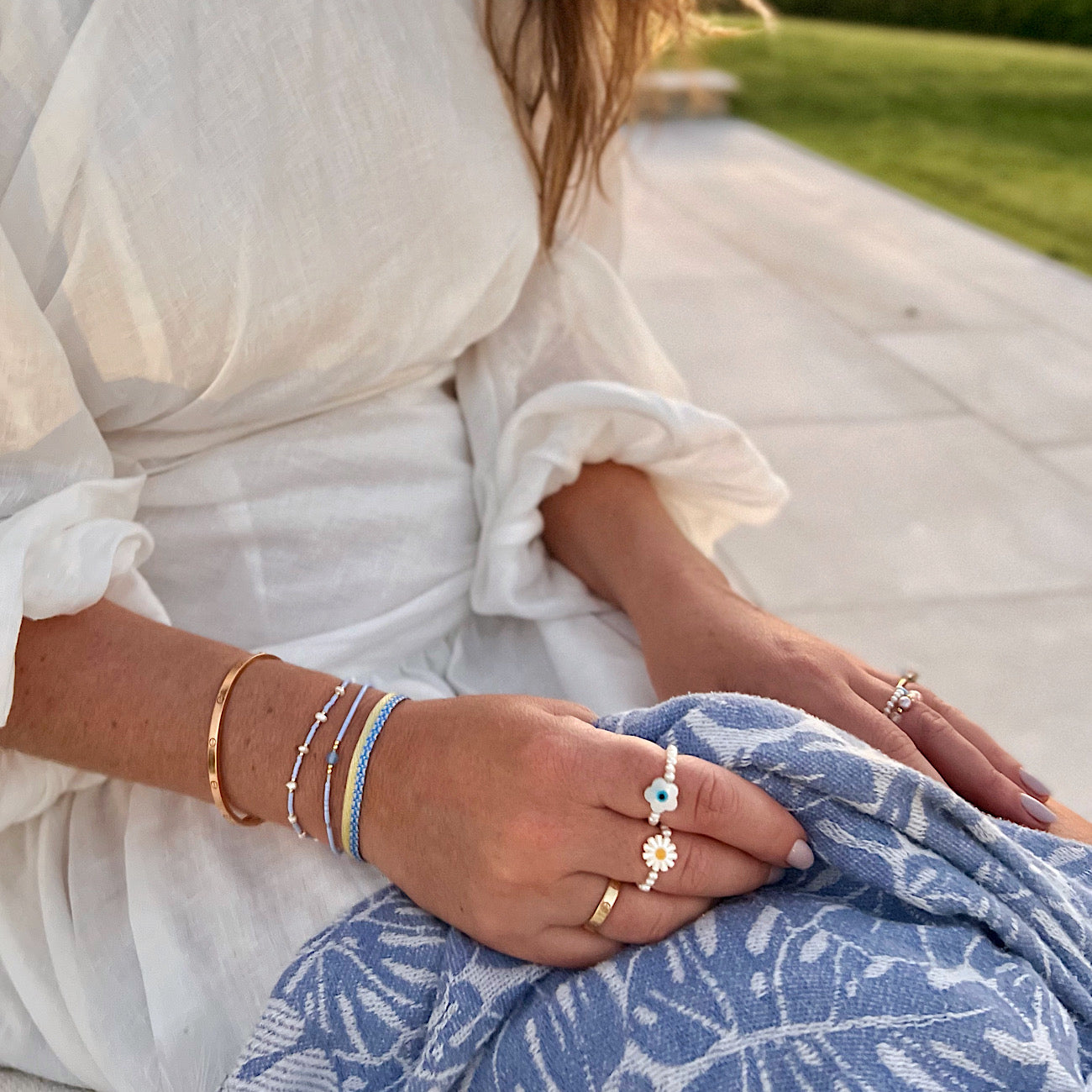 woman wearing light blue summer bracelet set and freshwater pearl stretch rings