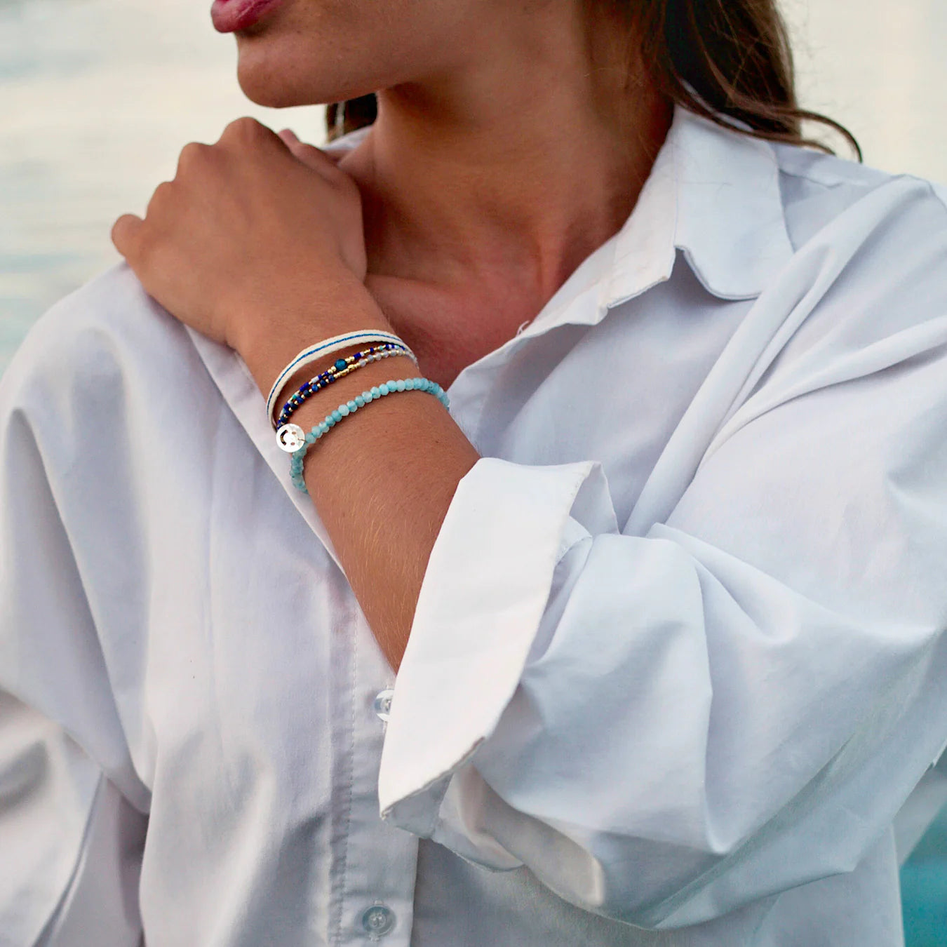 A woman at Santa Monica beach wearing dark blue bracelets.