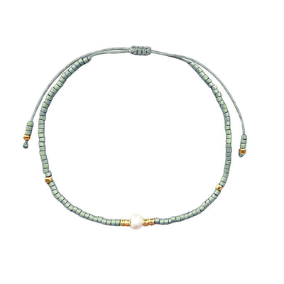 One pearl strand of a mint green 3-strand bracelet set.