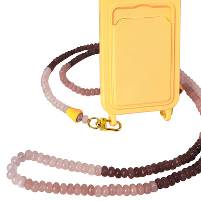 A trendy beach accessory: gold, brown, and nude gemstone necklace phone chain matched with a sunny yellow phone case.