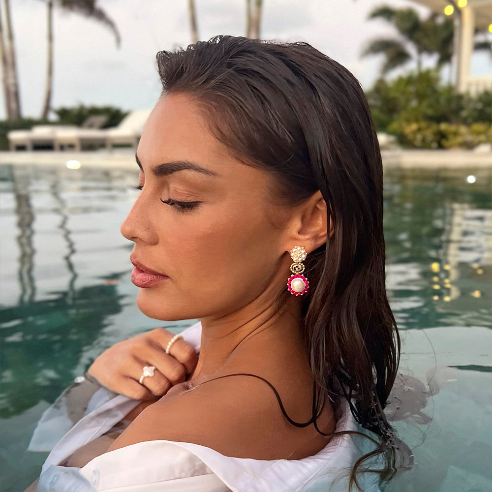 woman wearing big summer earrings with pink swarovski stones and dalmatis jasper gemstone
