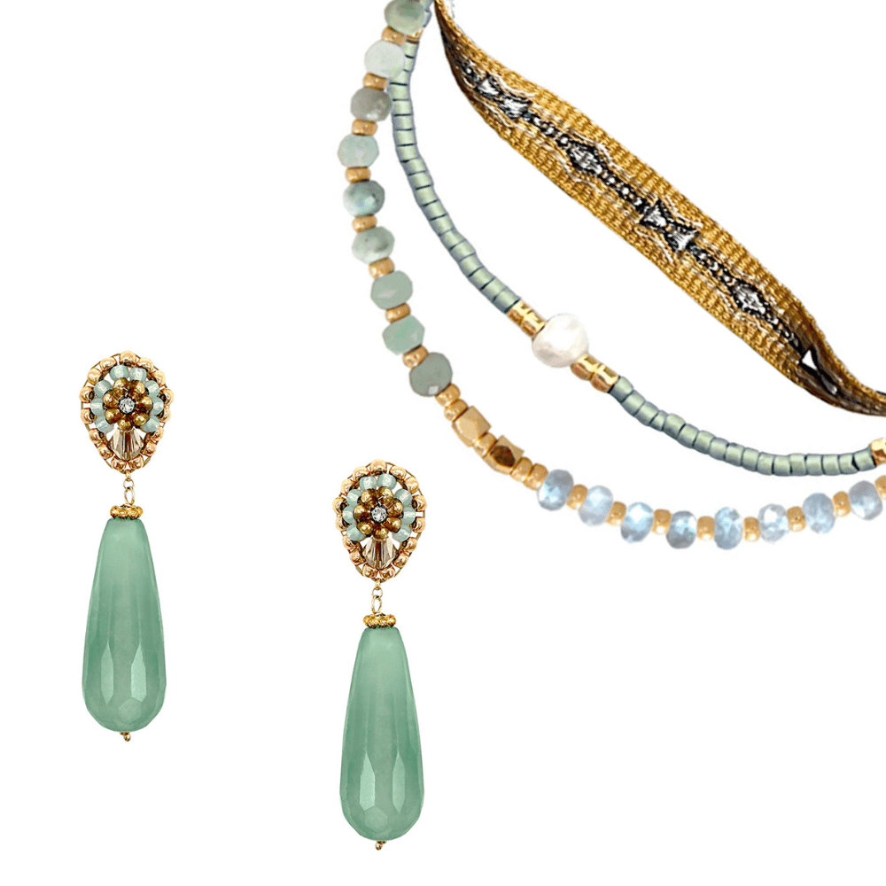 A pair of earrings with natural stone drops made of pearls and with Swarovski crystals beside a matching mint green 3-strand bracelet set.