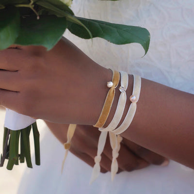 A bride on her wedding day wearing velvet bracelets with tasteful velvet bracelets which have real natural stones.