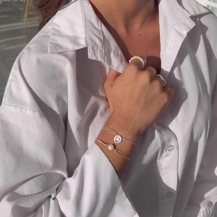 Armcandy combination with symbolbracelets and genuine pearls in a modern style.