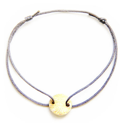 grey nylon thread bracelet with round gold plated pendant 