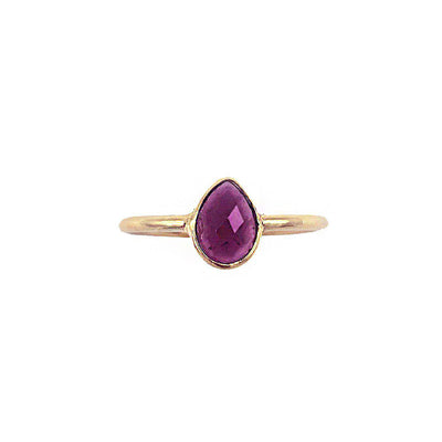 gold plated ring with purple teardrop shaped garnet gemstone 