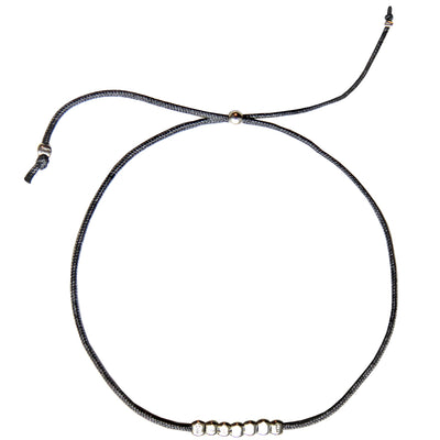 grey nylon thread bracelet with small round silver beads