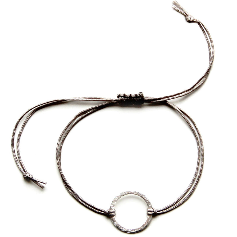 beige nylon thread bracelet with silver ring pendant