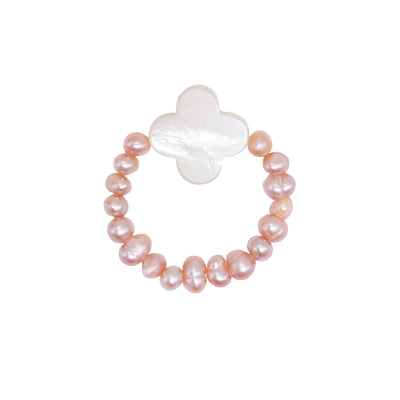 stretch ring out of small lilac freshwater pearls and a white flower shaped nacre