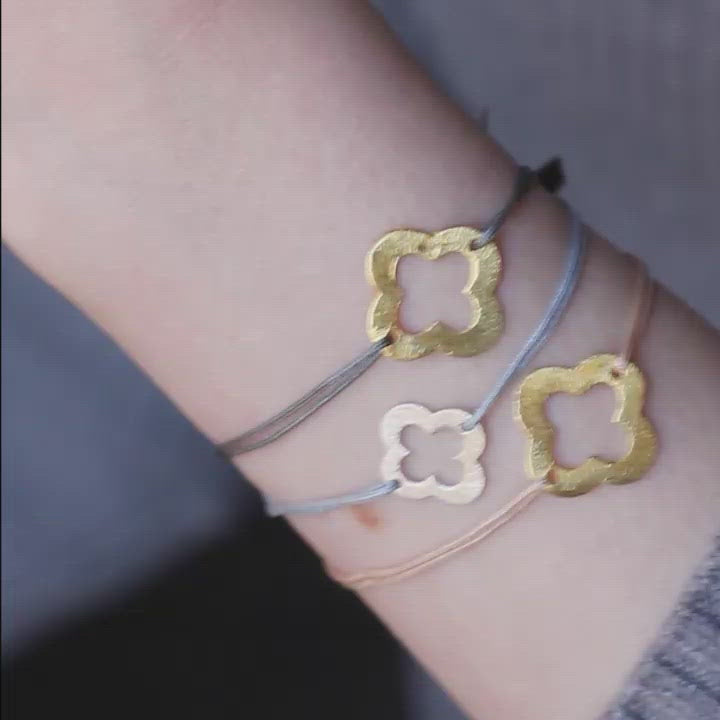 grey nylon thread bracelet with golden flower shaped pendant