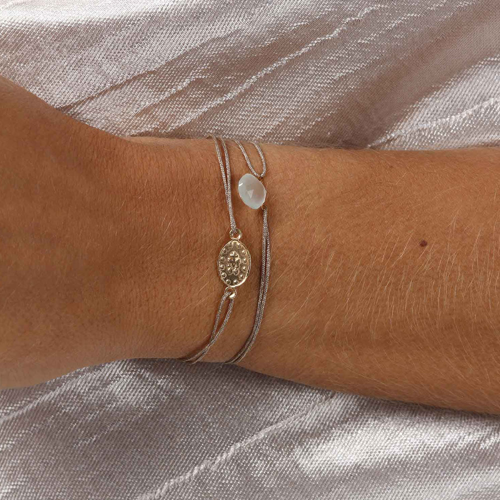 glittery beige nylon thread bracelet with light blue aquamarine gemstone
