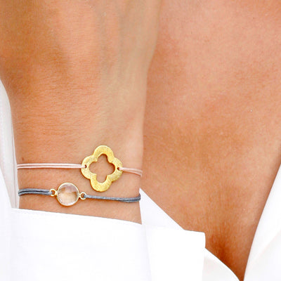 beige nylon thread bracelet with golden flower shaped pendant