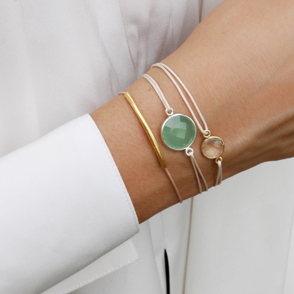 champagne coloured nylon thread bracelet with round green quartz gemstone