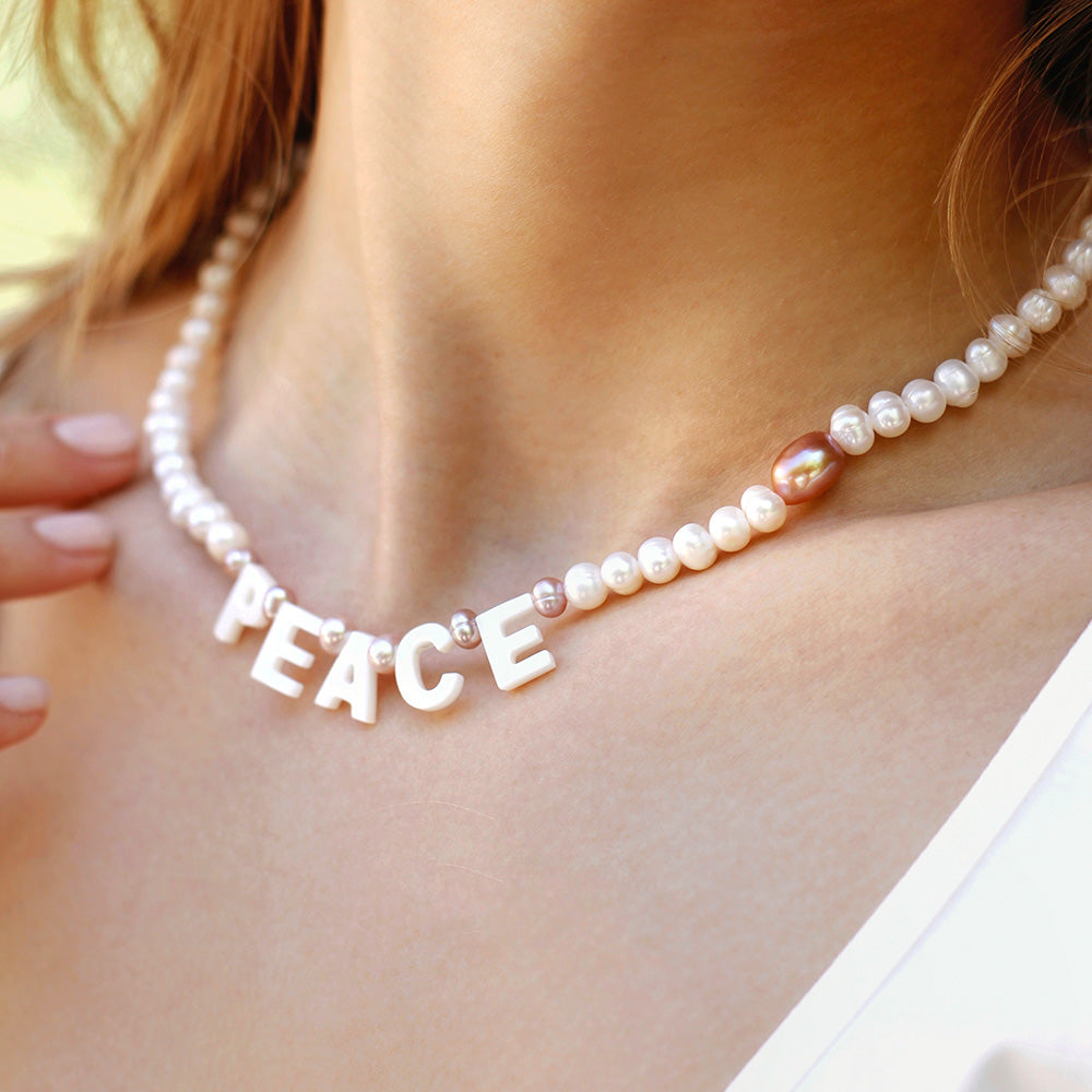 lilac and white freshwater pearl necklace with ‘peace’ letters out of nacre