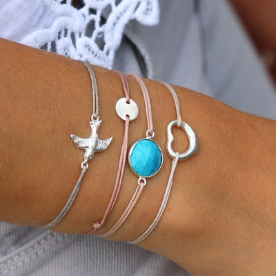 grey nylon thread bracelet with heart shaped silver pendant