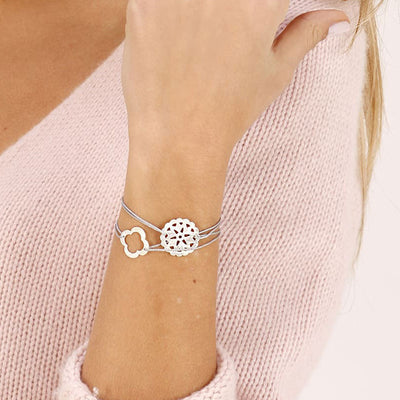 light grey nylon thread bracelet with round silver pendant with sun design