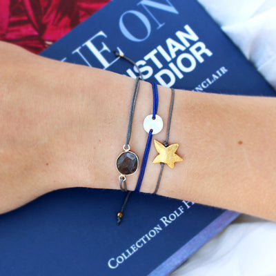 grey nylon thread bracelet with gold plated starfish pendant