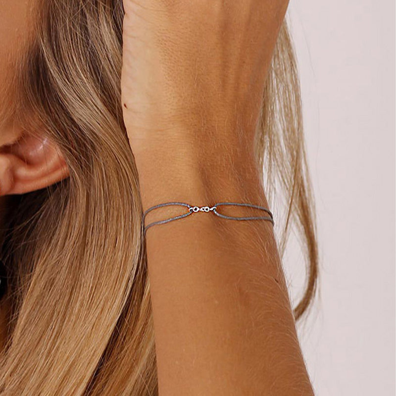 grey nylon thread bracelet with small silver chain