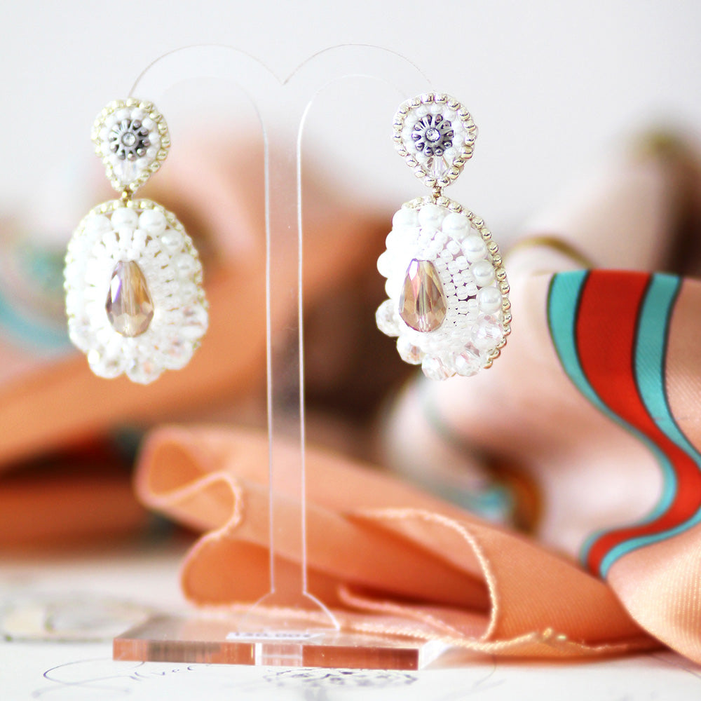white drop-shaped earrings with freshwater pearls and small white and silver beads