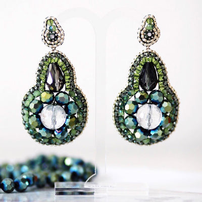 pear shaped statement earrings with white faceted rock crystal and beads in different green shades