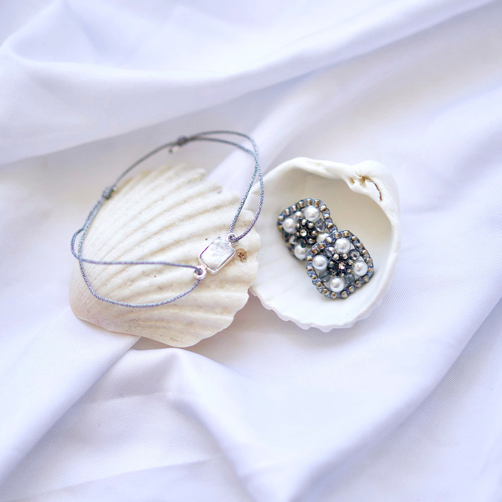glittery silver nylon thread bracelet with square cream coloured freshwater pearl 