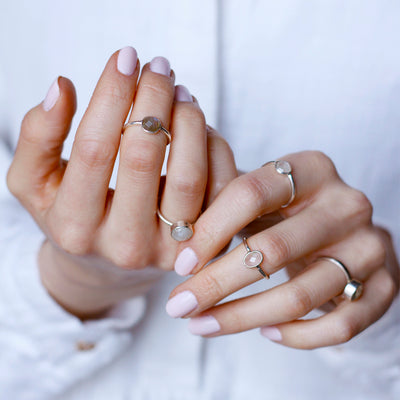 silver ring with round white labradorite gemstone