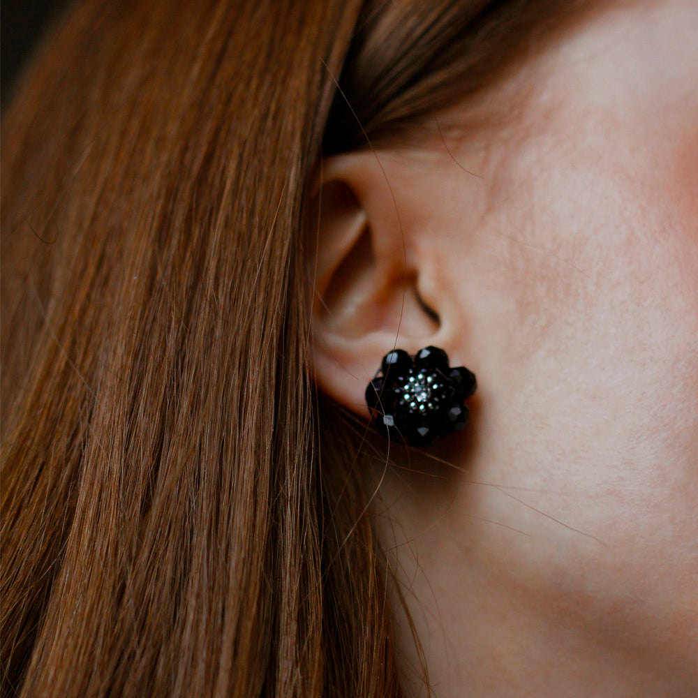 round silver earstuds made out of black glass beads