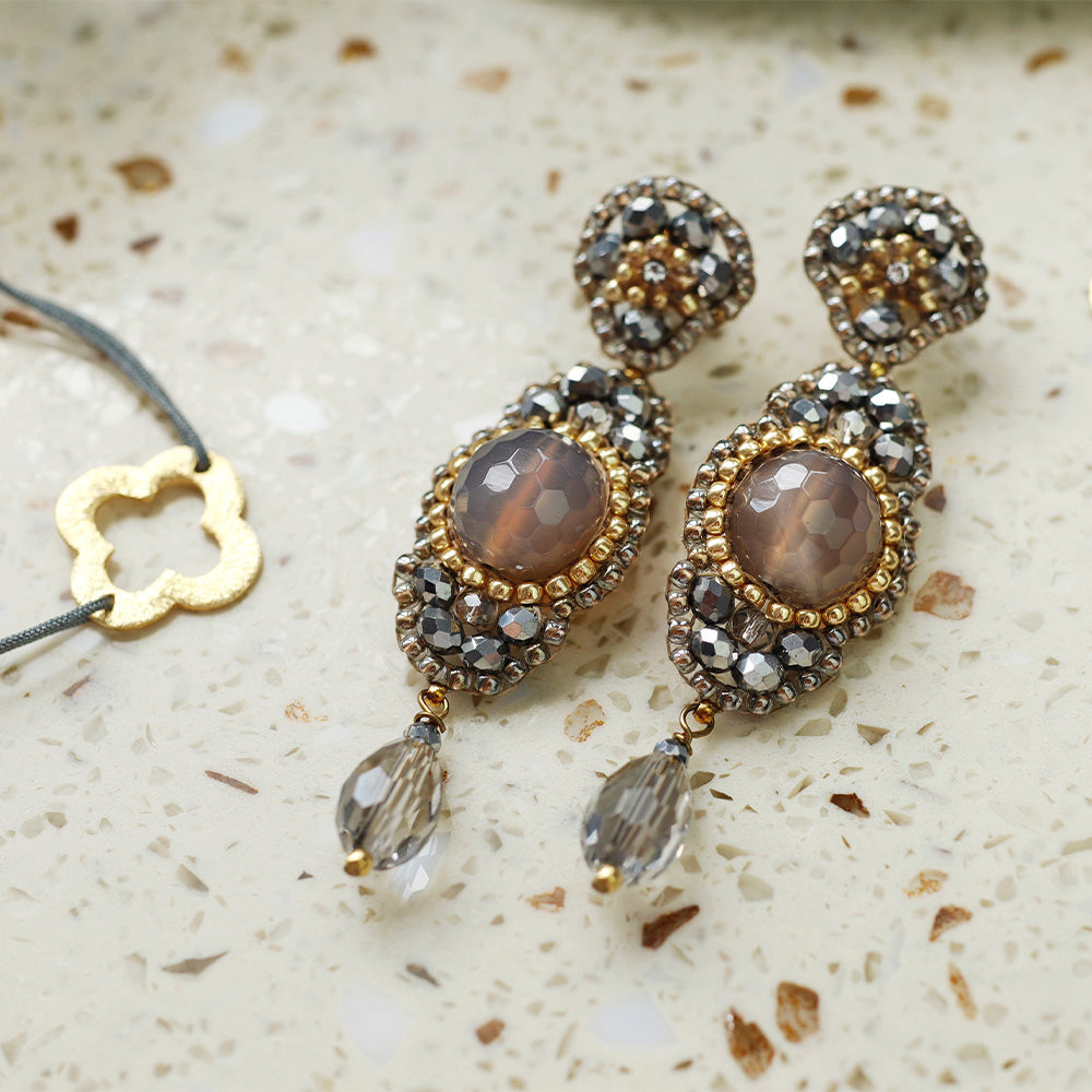 long grey statement earrings with round taupe-coloured agate stone and small golden beads