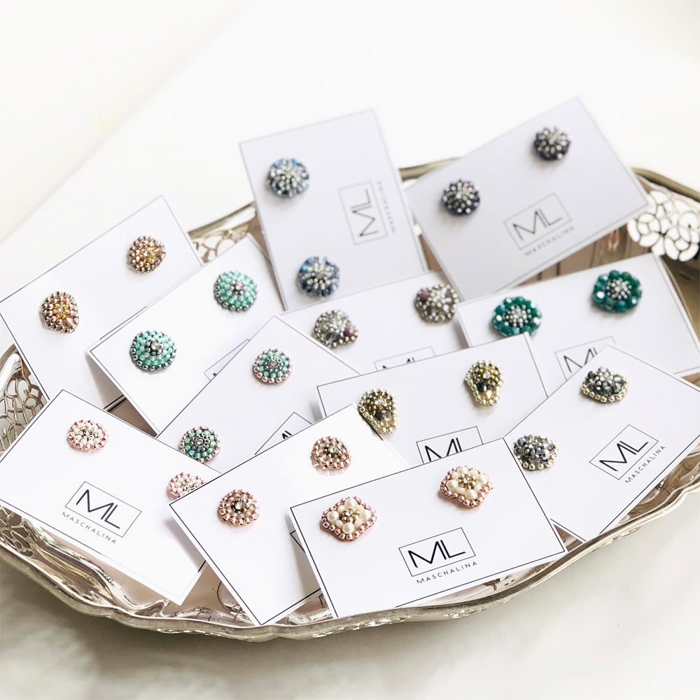 silver cone shaped earstuds made out of grey and purple beads