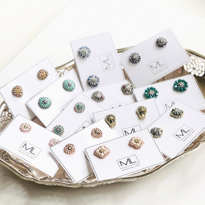 silver cone shaped earstuds made out of grey and purple beads