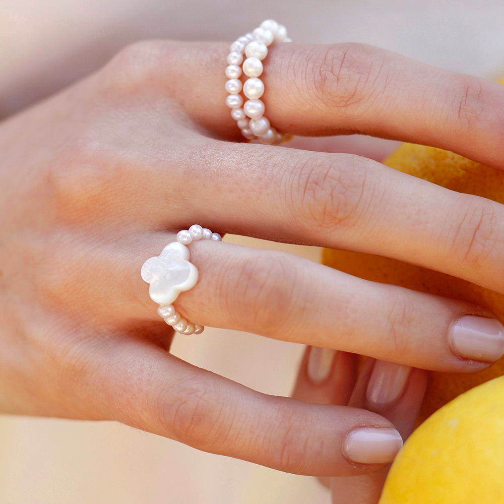stretch ring with small white freshwater pearls and flower shaped nacre 