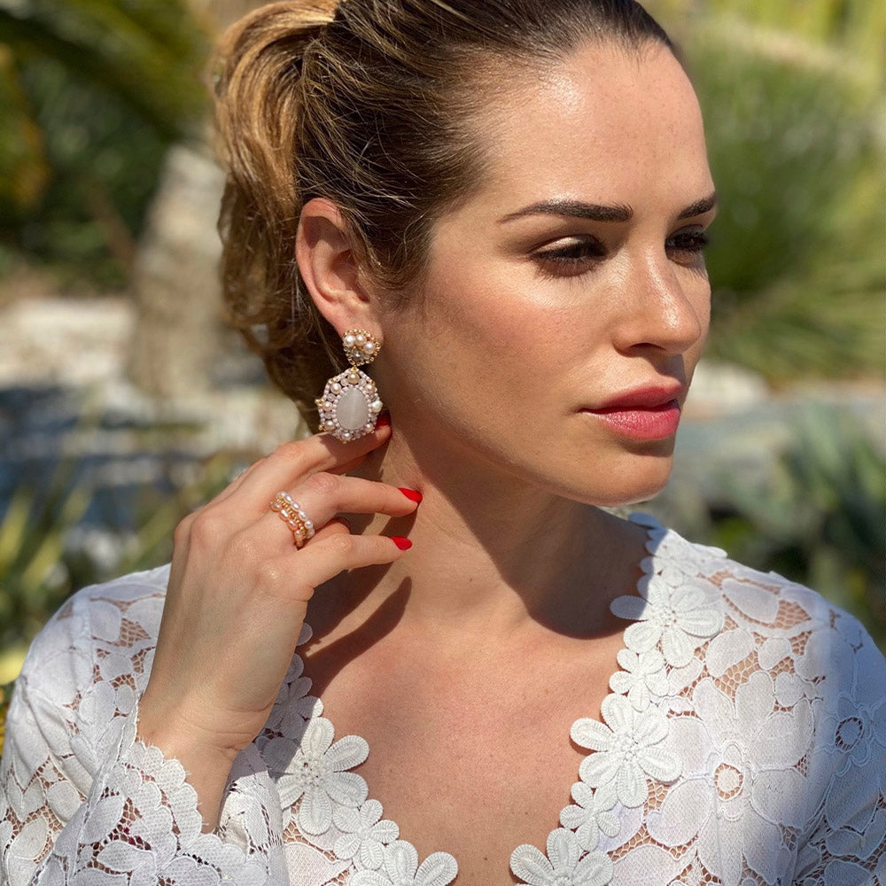 Lucreza Gavazzi wearing big light pink gemstone earrings with oval rose quartz and rose colored freshwater pearls in Monte-Carlo.