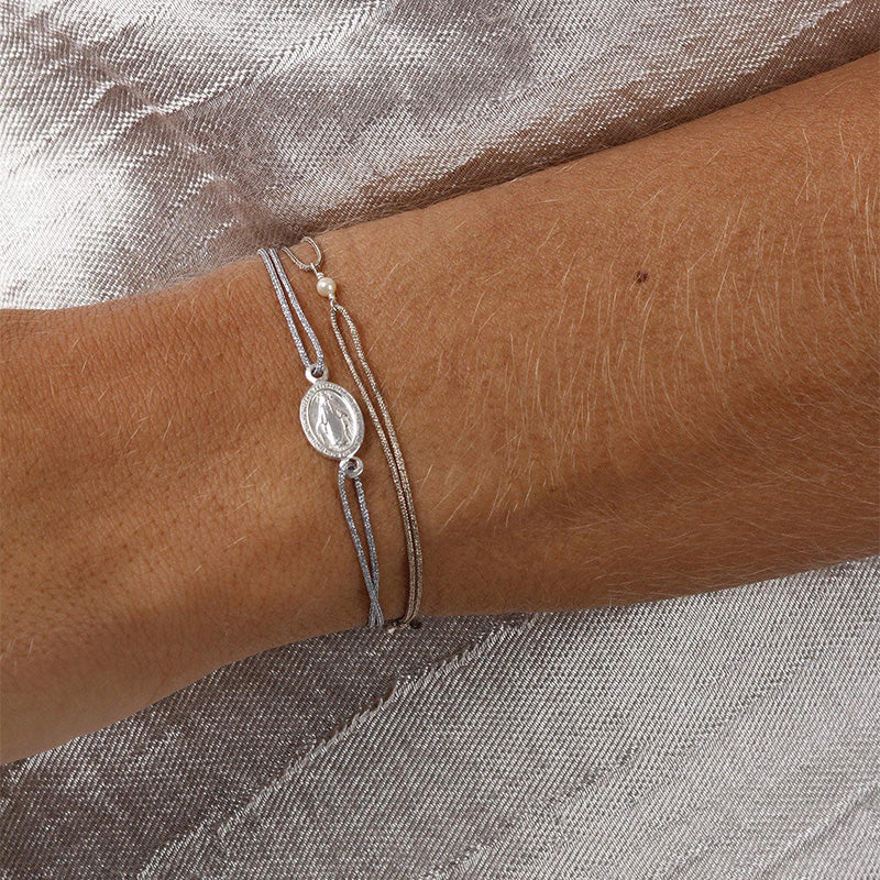glittery silver nylon thread bracelet with silver talisman 