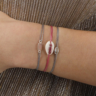 glittery silver nylon thread bracelet with silver cowrie shell 