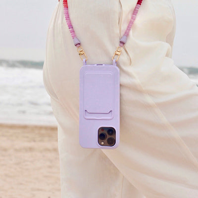 Beach day outfit with lilac purple phone case and matching berry phone chain necklace