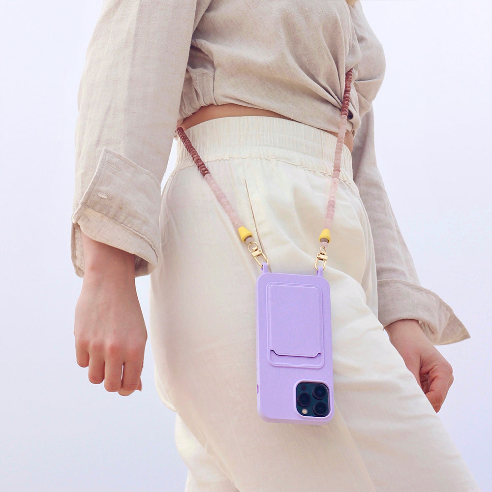 Trendy beach outfit with cute lilac phone case and matching nude phone chain necklace.