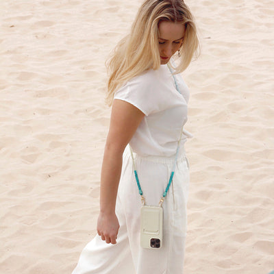 Wear your beach outfit with a trendy summer white phone case and turquoise ocean phone chain necklace.