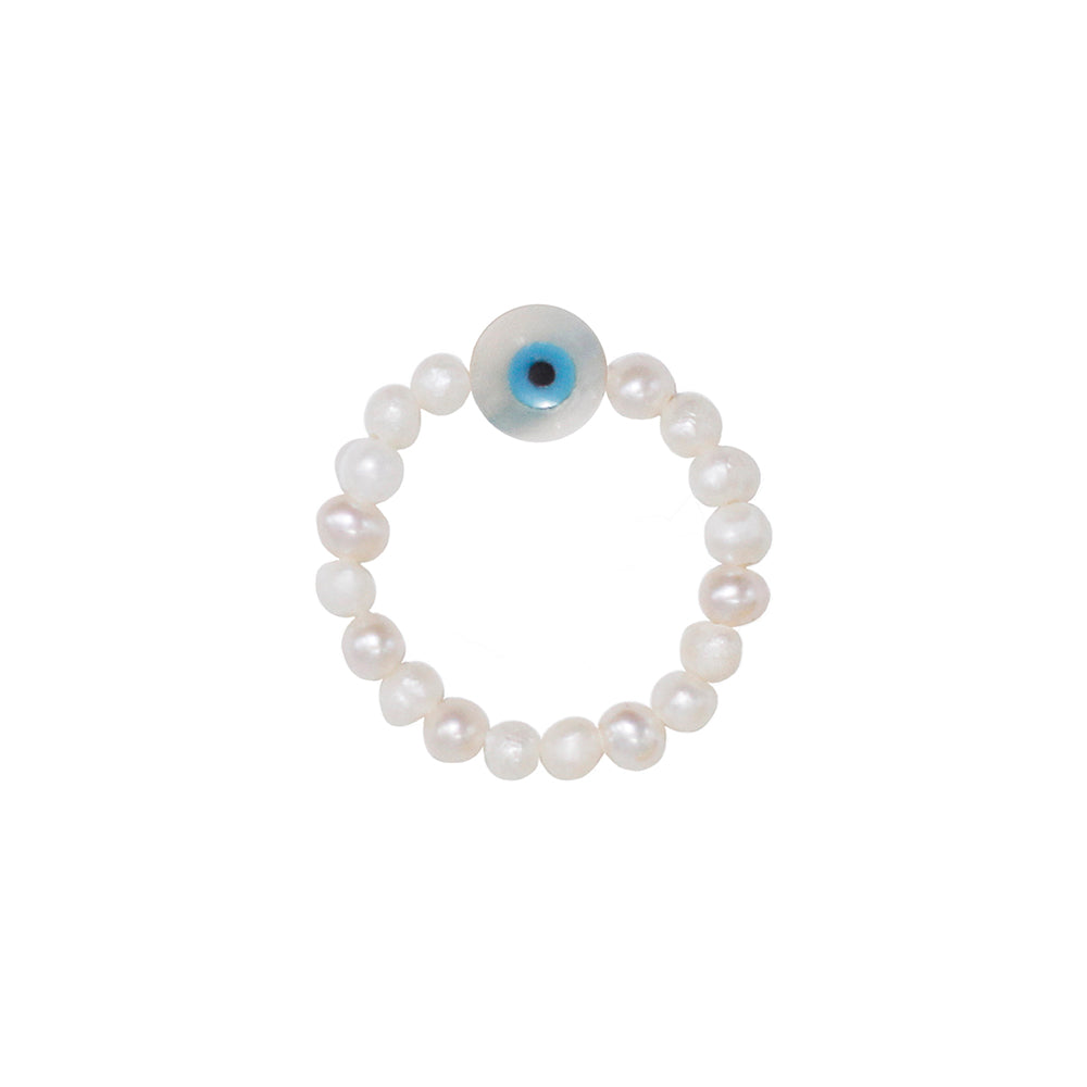 stretch ring with small white freshwater pearls and small nazar eye pendant out of nacre