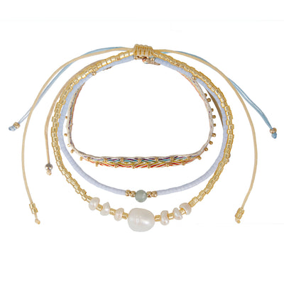 set of 3 bracelets with freshwater pearls, light blue beads with a light green gemstone and gold details 