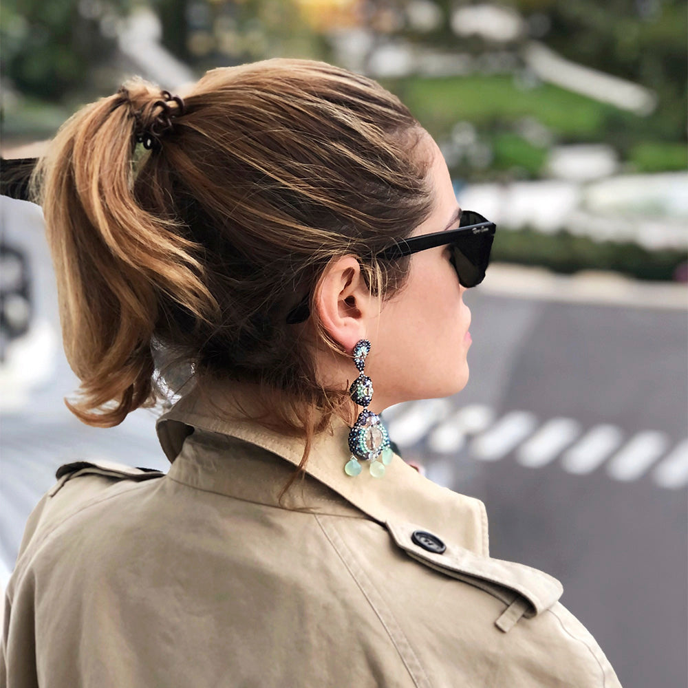 Lucreza Gavazzi wearing big earrings with white rock crystals, mintgreen amazonite stone and small beads in different blue shades combined with burberry coat in Monte-Carlo.