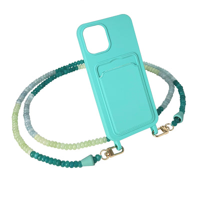 The perfect summer accessory: an ocean inspired phone chain necklace with turquoise, sage green, and light blue gemstones with a matching turquoise blue phone case.