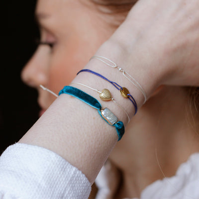 dark blue nylon thread bracelet with round gold plated pendant 