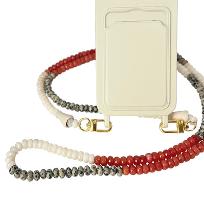 The perfect beach day summer accessory: blush white phone case and a matching summer berry red, and spotted gemstones phone chain necklace.