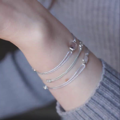 glittery silver nylon thread bracelet with square purple amethyst gemstone